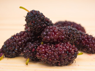 Group of mulberries on wood table