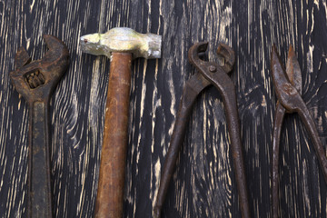 Heap of old instruments. Pliers, hammer, wrench and scissors.