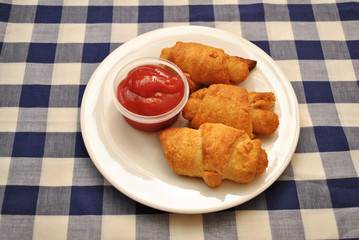 Fish Sticks Wrapped in Golden Croissant Rolls Served with Catsup  