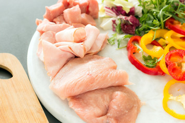 Raw fresh marbled meat Steak with seasonings, herbs and vegetables on grey concrete background, top view