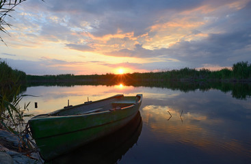 Naklejka premium fisherman boat at sunset