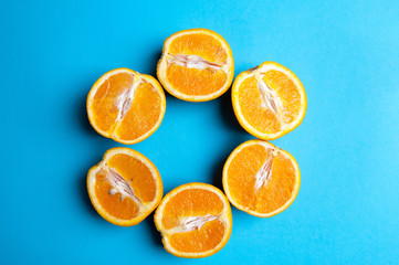 Cut oranges from above on blue background