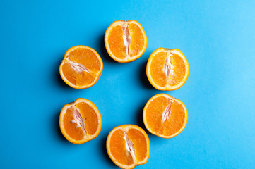 Cut oranges from above on blue background