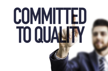Business Man Pointing the Text: Committed to Quality