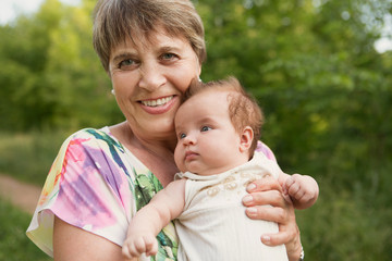 Fototapeta premium the grandmother walks with the baby granddaughter