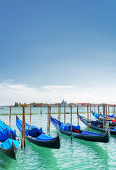 Fototapeta na wymiar Several gondolas parked beside the Riva degli Schiavoni. Venice