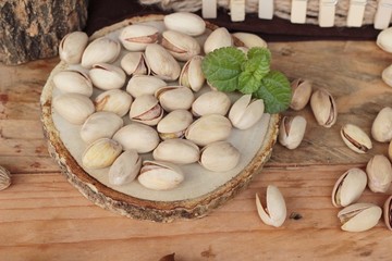 Pistachios is delicious for healthy on wood background.