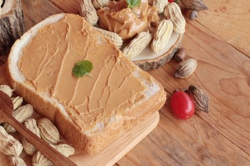 Peanut butter smeared on bread is delicious.