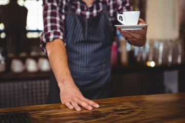 Fototapeta na wymiar Waiter handing over a coffee