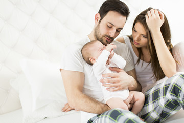 Obraz na płótnie Canvas Happy family with newborn baby