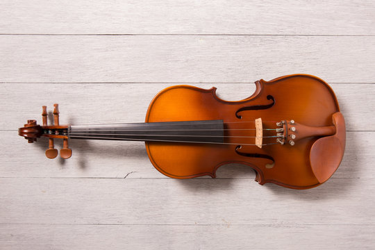 still life of vintage violin on white wooden background