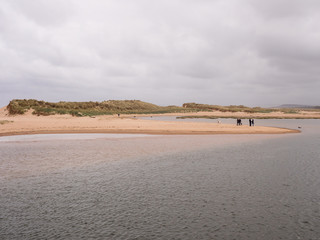 Visitors enjoying a walk along the beach at Lossiemouth, Morray Firth, Scotland, UK,