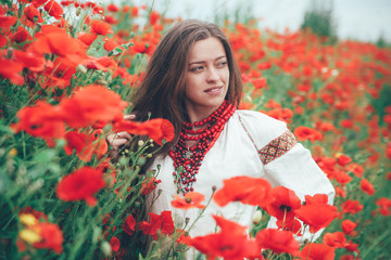 beautiful girl in the poppy field. Ukrainian national clothes
