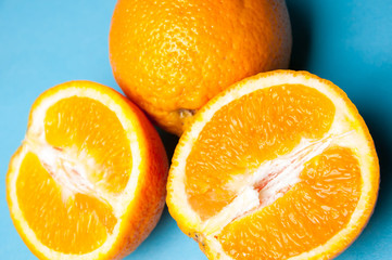 Fresh oranges isolated on a blue background