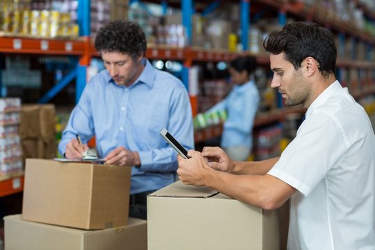 Focus of managers are working in the middle of cardboard boxes 