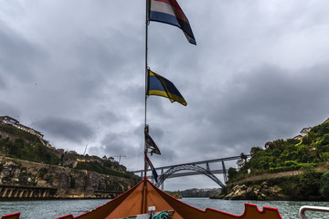 Fototapeta na wymiar Sailing in Porto under the bridges