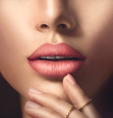 Perfect woman's sensual lips with fashion natural beige matte lipstick makeup