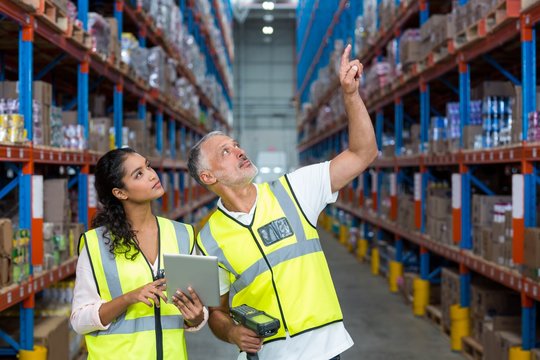 Portrait of workers are looking up and pointing shelves