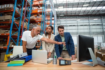 Low angle view of worker team looking a computer 