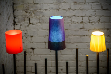 Closeup with lighted colorful lamps. Horizontal view with three