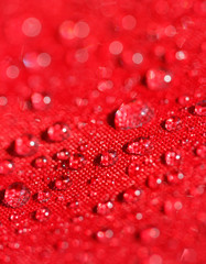water drops on the red umbrella fabric