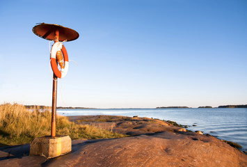 Lifebelt at coast near sea © RistoH