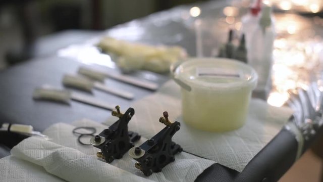 tattoo artist preparing the ink containers before starting the tattoo work