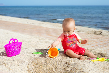 Baby playing at the seaside