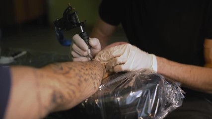 Tattoo artist make tattoo at the studio