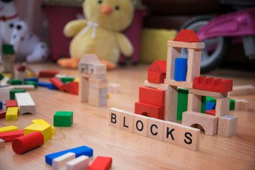 Scattered toy blocks. Background  with inscription. Shallow depth of field.