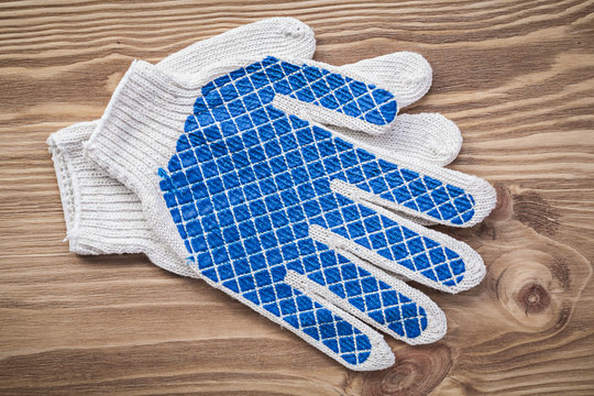 Protective gloves on wooden board construction concept