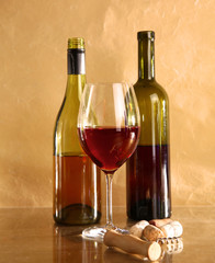 wine bottle and wine glass on a glass table