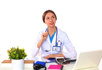 Obraz premium young girl doctor sits at a desk in the Office