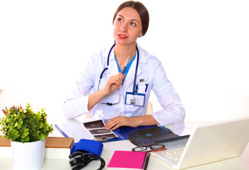 young girl doctor sits at a desk in the Office