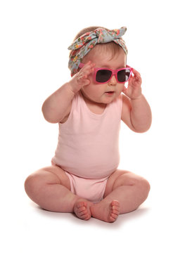 Baby girl wearing vintage floral headband and sunglasses