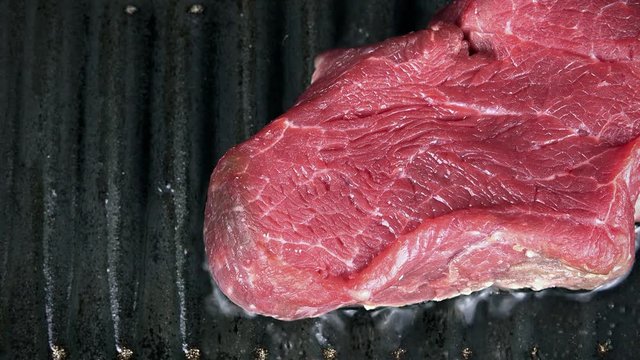 Beef Steak in a pan (selective focus) as high detailed 4K UHD footge