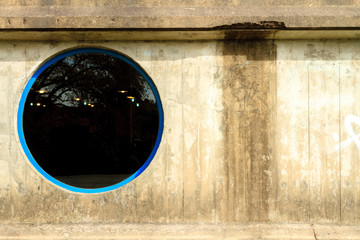 Round window on concrete wall