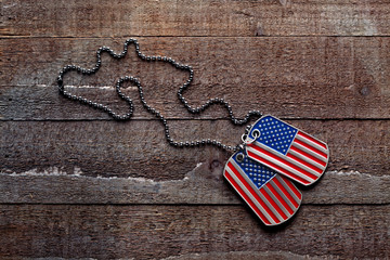 USA dog tags on wooden background