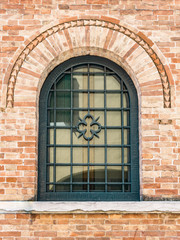 Decorated arched windows of a medieval building.