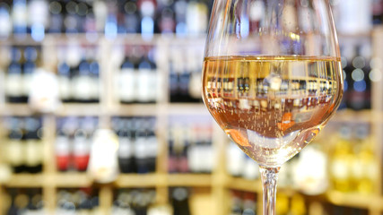 White wine glass in an Italian wine bar. - obrazy, fototapety, plakaty