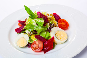 Salad with eggs and cherry