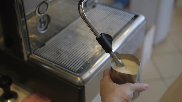 Hand girl baristas dub coffee from holder coffee machines