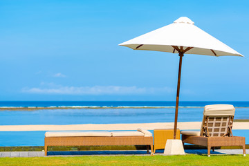 Sun umbrella & Daybeds overlooking beautiful tropical beach