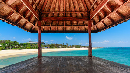 Looking out of a hut on a beautiful day at a tropical beach in Bali, Indonesia. - Powered by Adobe