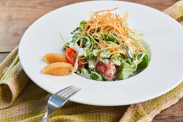 Healthy salad of pike caviar and vegetables served on white plate