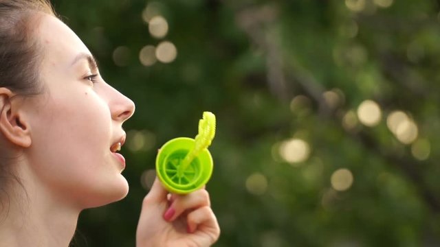 footage woman blowing bubbles on nature.