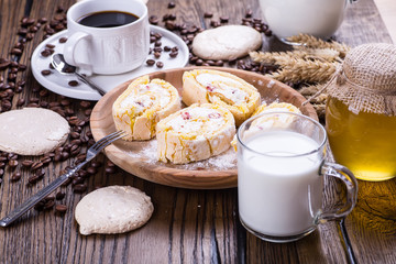 black coffee on a wooden background with dessert
