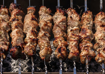 shish kebab on skewers roasted in the coals.  Cooking barbecue.