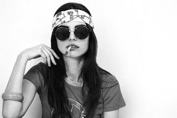 Beautiful hippy girl portrait smoking and wearing sunglasses