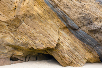 Rock on sandy beach.